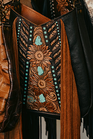 
                  
                    Heritage Brand lyrik bag #1304 with floral embossing and turquoise stone accents.
                  
                