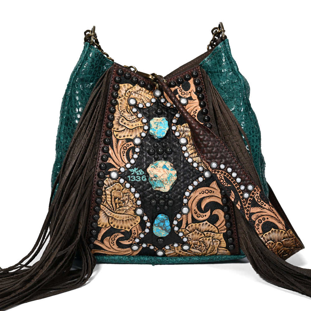 
                  
                    Heritage Brand lyrik bag #1336 with turquoise accents and fringe details on a white background.
                  
                