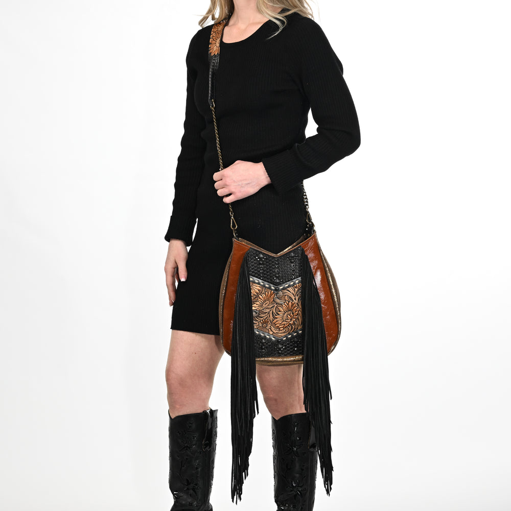 
                  
                    A woman in a black dress and Heritage Brand lyrik bag #1303 glasses cases.
                  
                