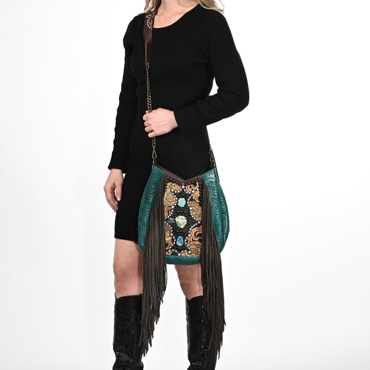 
                  
                    Woman modeling a black sweater, patterned skirt with fringe, and black knee-high glasses cases, carrying a Heritage Brand lyrik bag #1336.
                  
                