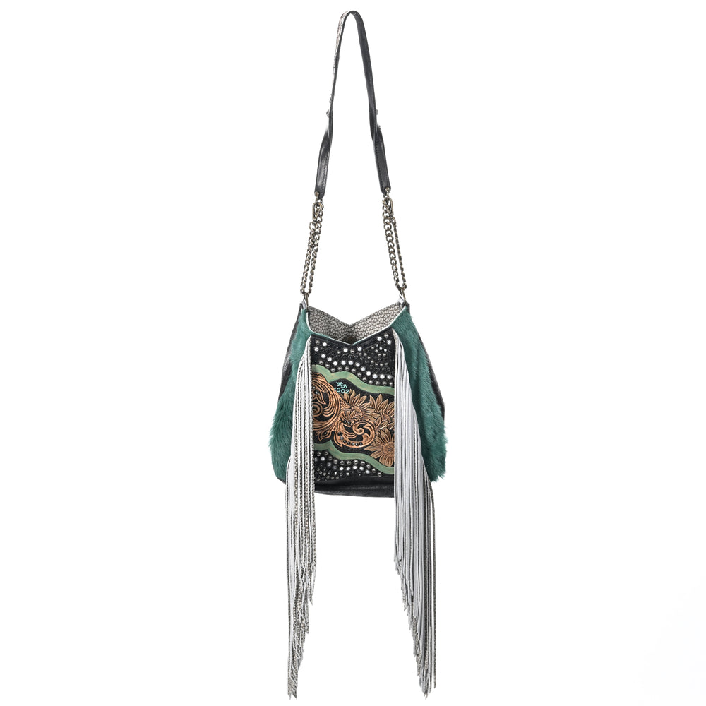 Heritage Brand's lyrik bag #1302, a American west-style shoulder bag with fringe and hand-tooled details on a white background.