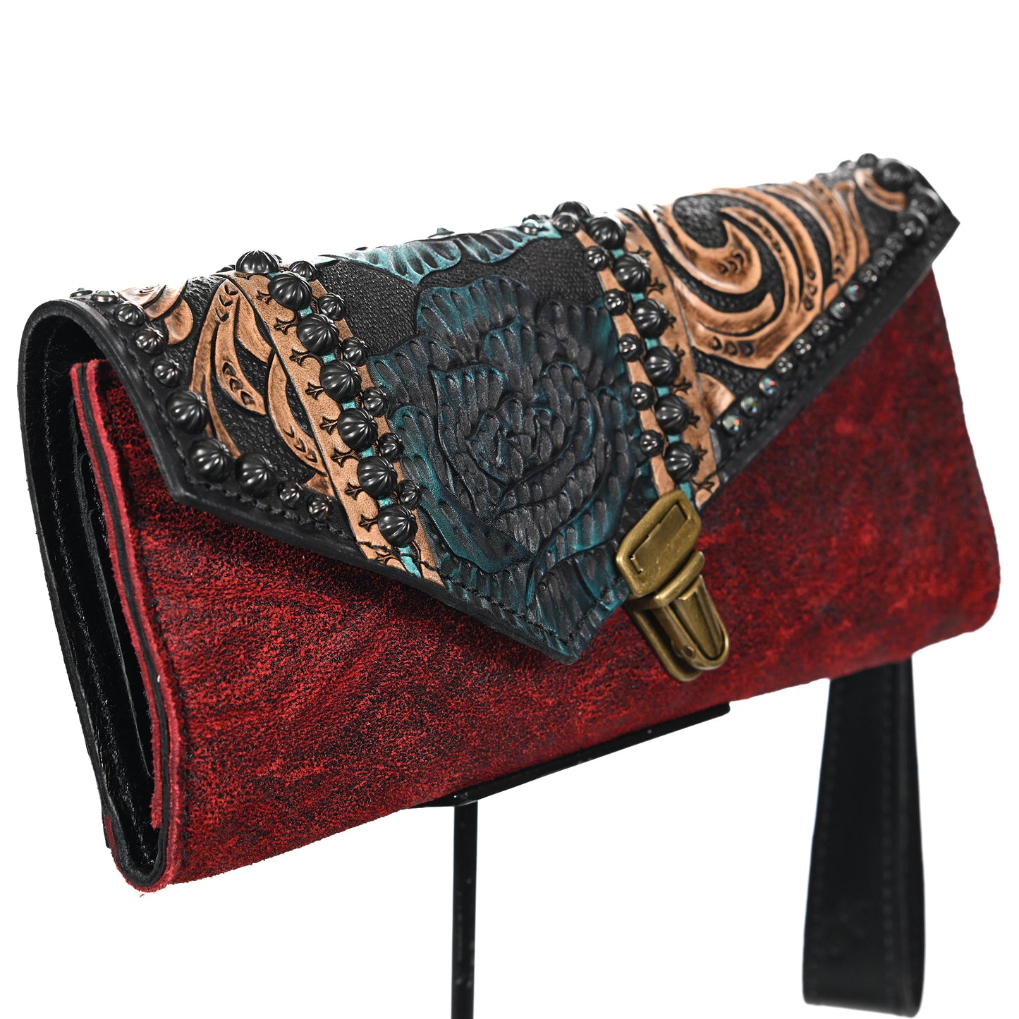 
                  
                    A red and black textured nola clutch #1091 with floral embossing and metallic accents by Heritage Brand.
                  
                