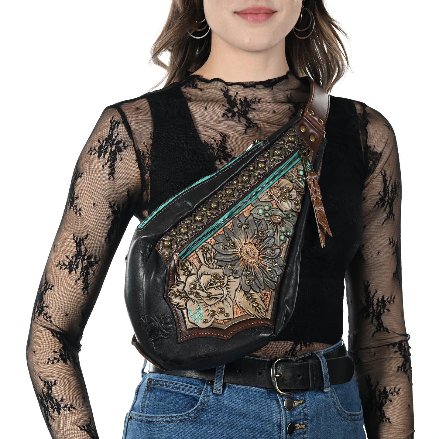 
                  
                    Woman wearing a black lace top carrying a Heritage Brand fyra bag #420.
                  
                