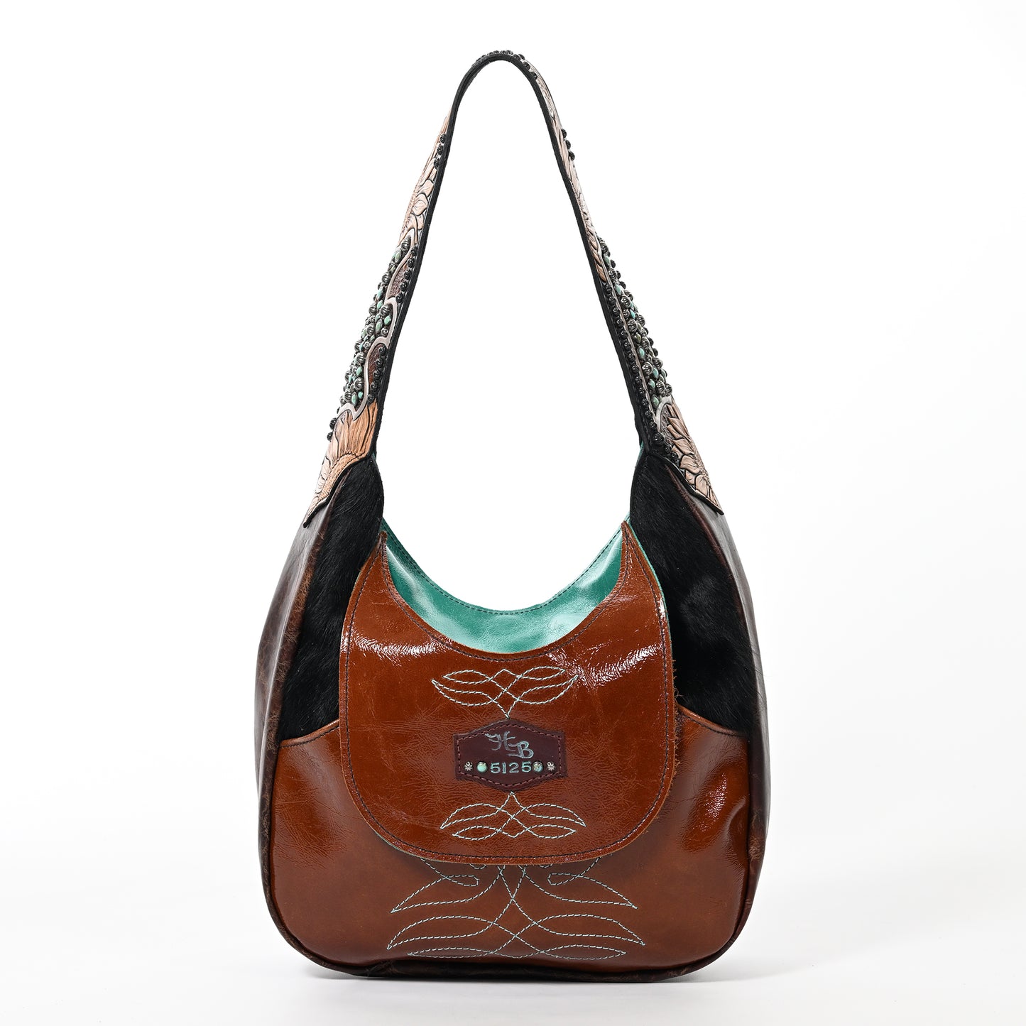 
                  
                    A brown leather marilyn bag #5125 with black and patterned details, isolated on a white background by Heritage Brand.
                  
                