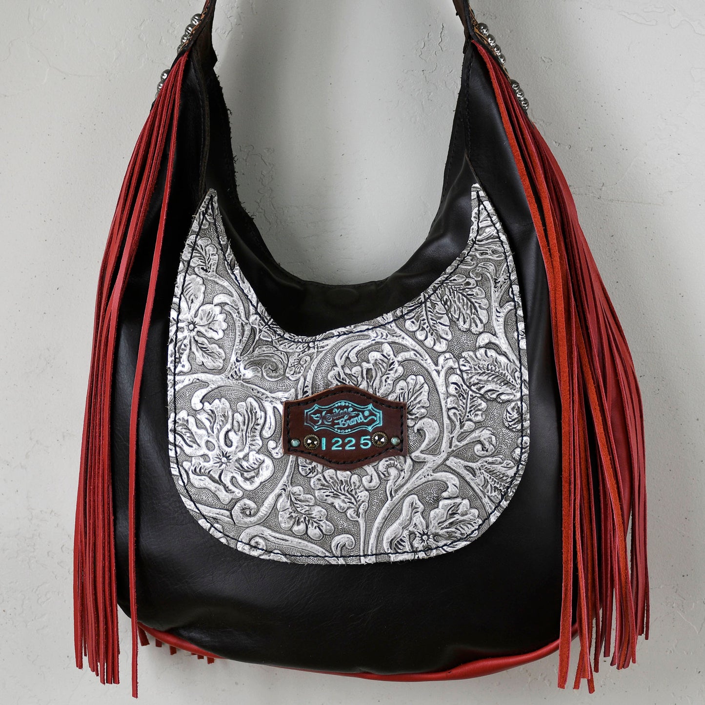 
                  
                    A Heritage Brand marilyn bag #5 with red fringe detail and a decorative buckle.
                  
                