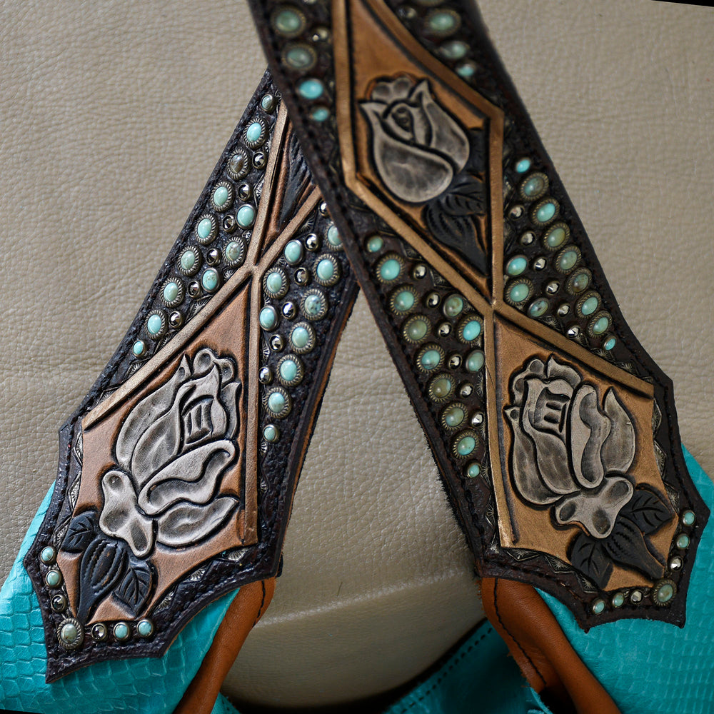 
                  
                    Close-up of an ornate Marilyn Bag #19 strap by Heritage Brand with embossed floral patterns and studded with turquoise stones.
                  
                