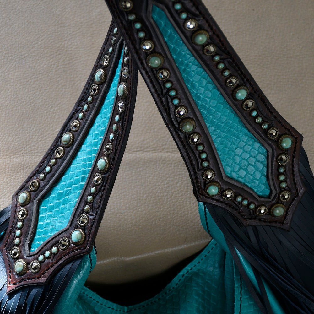 
                  
                    Close-up of embellished Heritage Brand marilyn bag #21 with turquoise texture and studded details.
                  
                