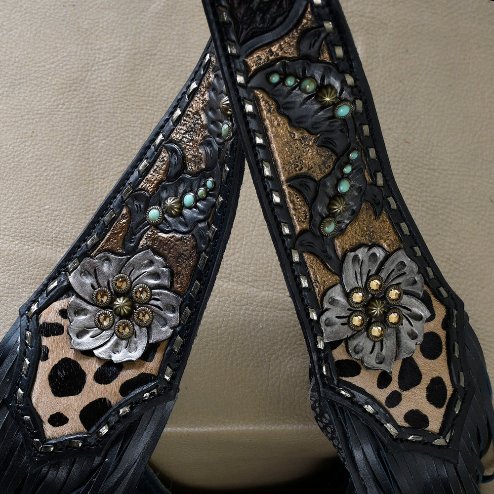 
                  
                    Close-up of ornate western-style leather belt with flower and turquoise accents, the Marilyn Bag #24 by Heritage Brand.
                  
                