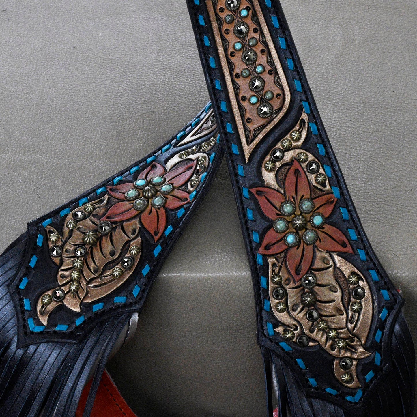 
                  
                    Close-up of a pair of Heritage Brand marilyn bag #31 with floral embossing and metal stud accents.
                  
                