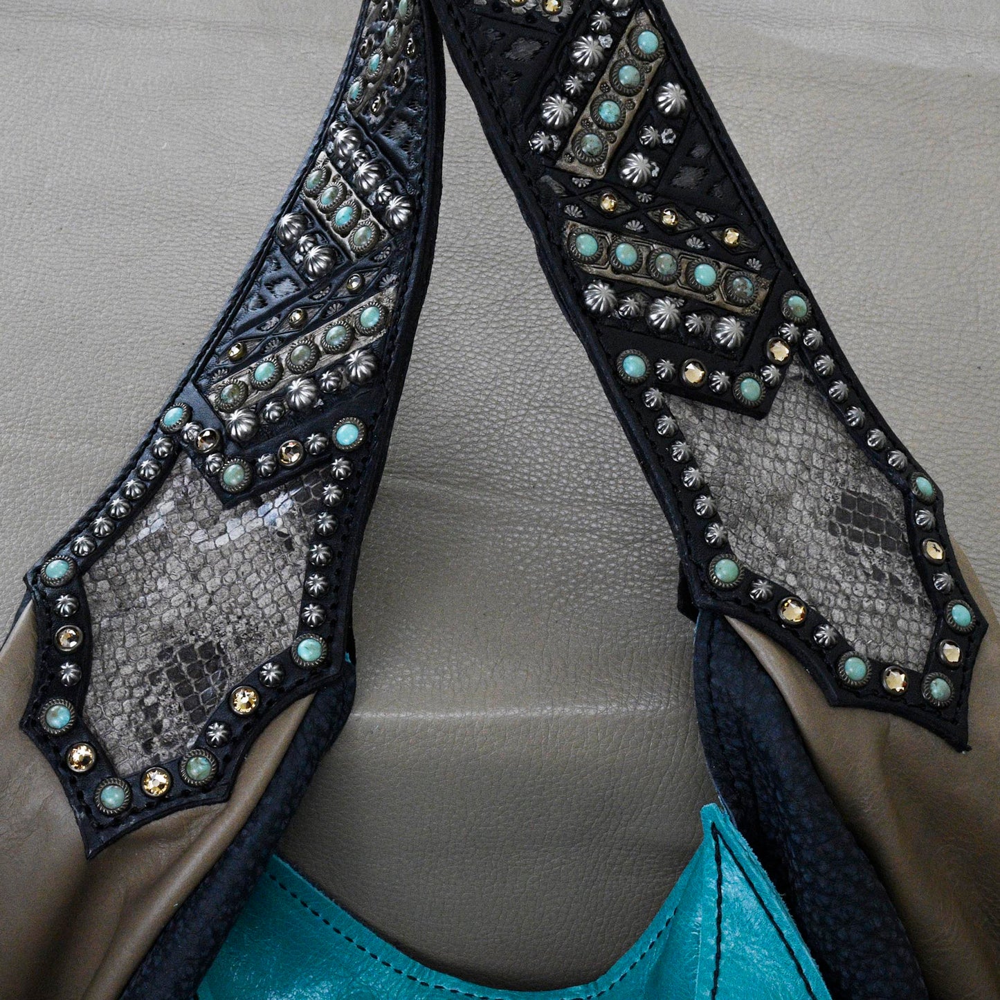 
                  
                    Close-up of Heritage Brand's marilyn bag #1259 in embellished black and turquoise leather with studs and intricate textures.
                  
                