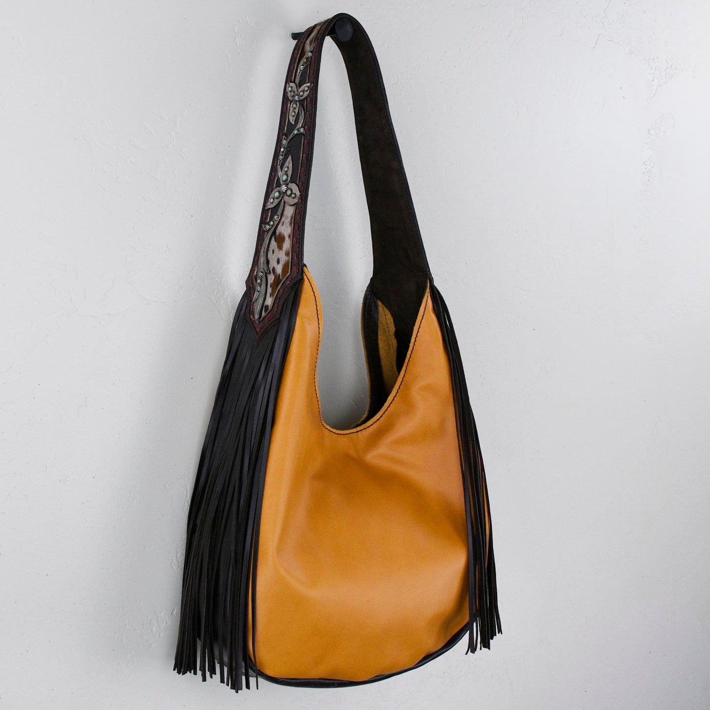 
                  
                    Marilyn bag #1260 with black fringe and hand-tooled strap against a white background. (Heritage Brand)
                  
                