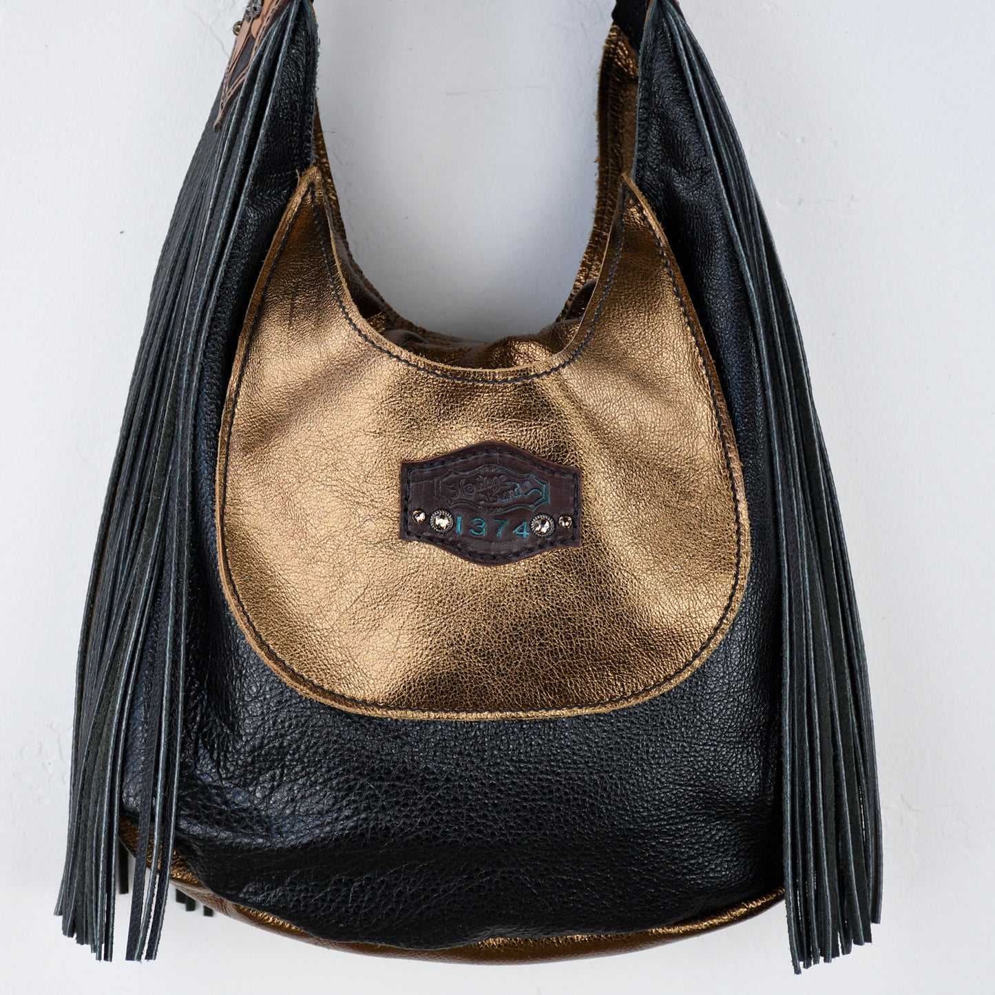
                  
                    Marilyn bag #650 with fringe detailing and a logo patch by Heritage Brand.
                  
                