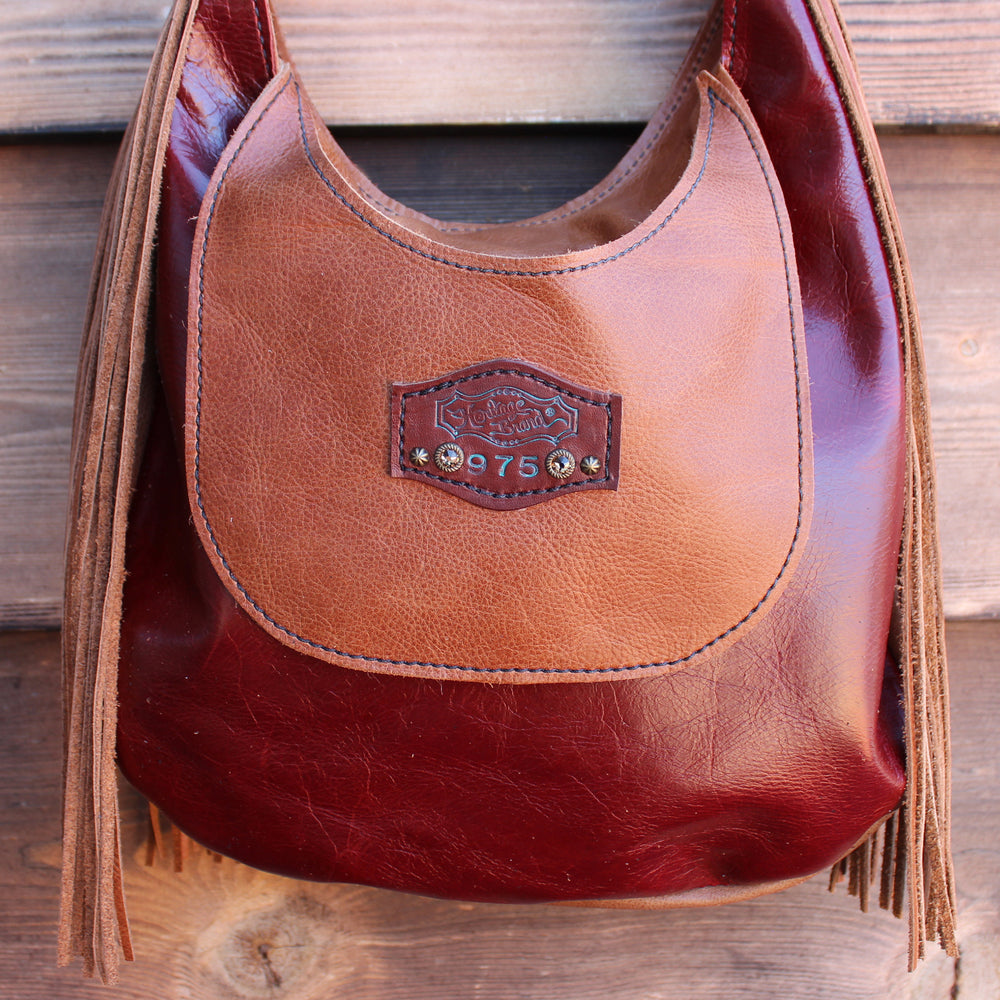 
                  
                    Marilyn bag #975 by Heritage Brand with fringed detail on a wooden background.
                  
                