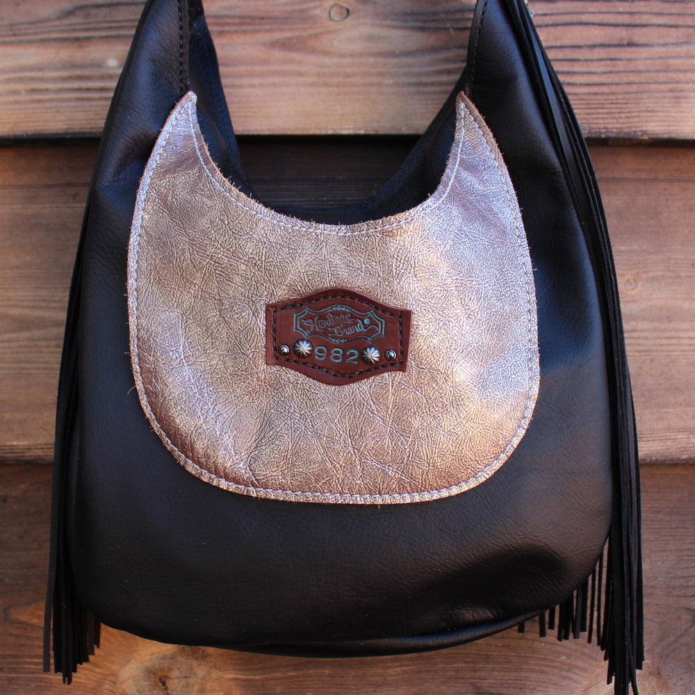 
                  
                    Marilyn bag #982 by Heritage Brand with fringes on a wooden background.
                  
                