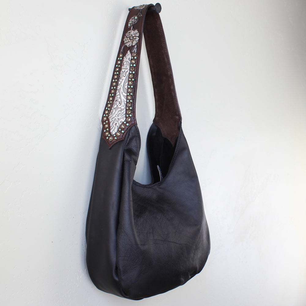 Marilyn bag #1203 by Heritage Brand with embellished strap hanging against a white wall.