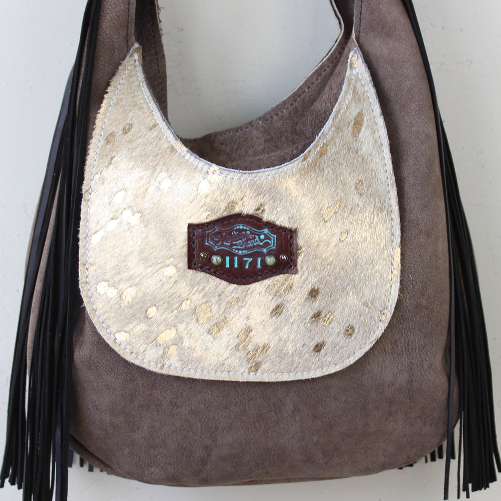 
                  
                    Heritage Brand Marilyn bag #1171 in brown suede with gold accents and black fringe detail.
                  
                