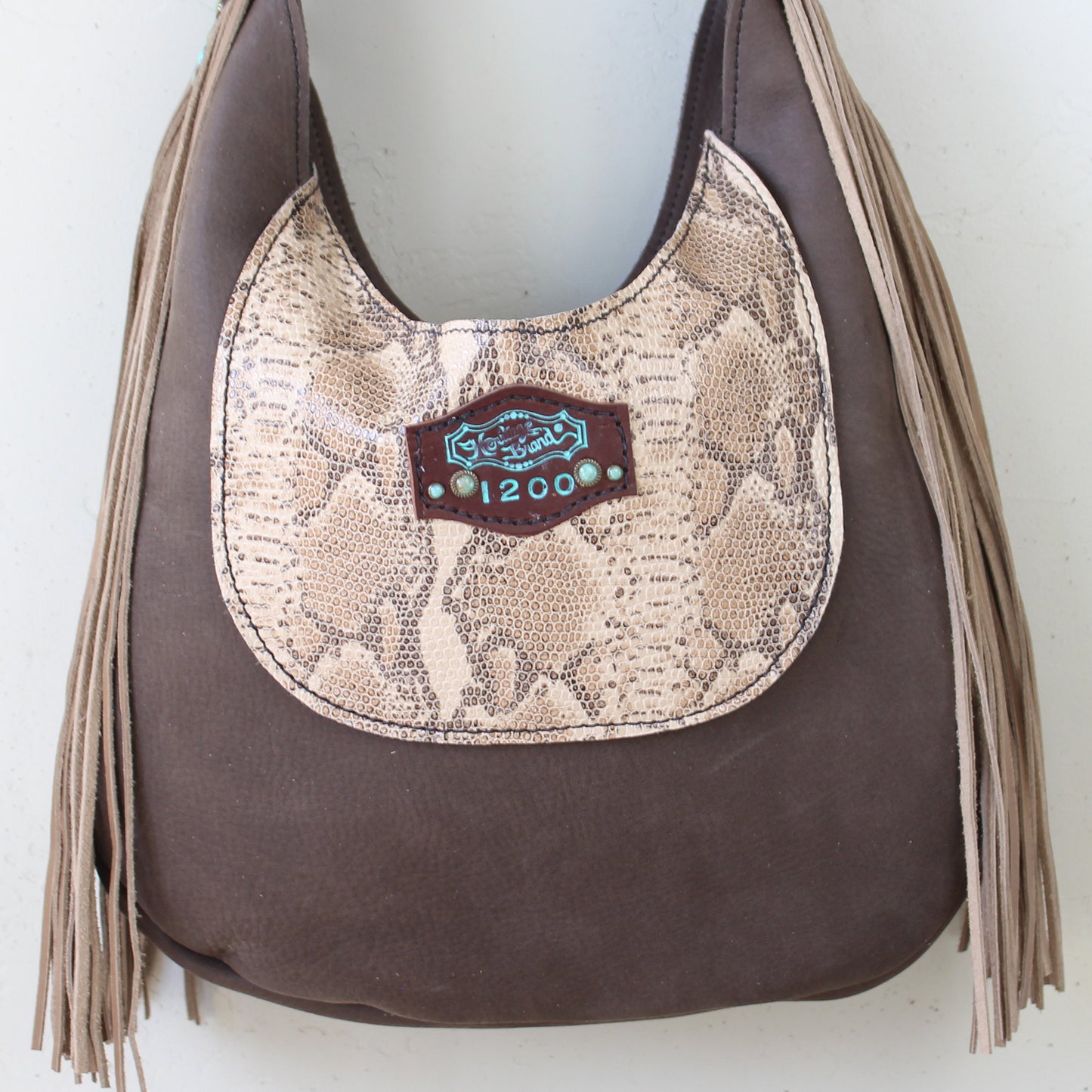 
                  
                    Marilyn bag #1200 by Heritage Brand with tassel details and an animal print accent.
                  
                