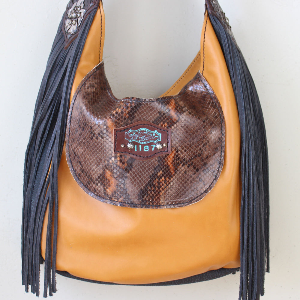 
                  
                    Brown and tan Marilyn bag #1188 by Heritage Brand with fringe and a snakeskin patterned flap.
                  
                